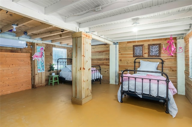 bedroom with finished concrete flooring, beamed ceiling, and wood walls