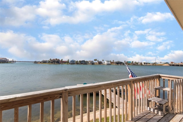 wooden terrace featuring a water view