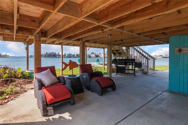 view of patio featuring a water view and stairway