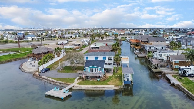 birds eye view of property with a water view and a residential view