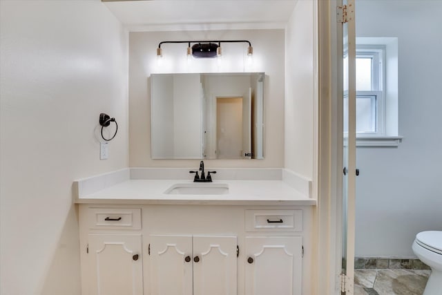 bathroom featuring vanity and toilet