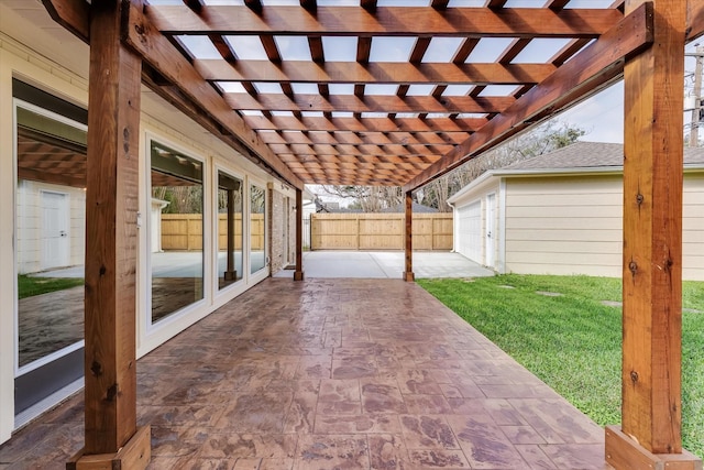 view of patio / terrace featuring a garage and a pergola