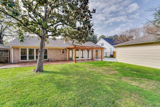 rear view of property featuring a yard and a patio