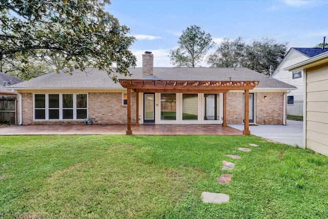 back of house featuring a yard, a pergola, and a patio