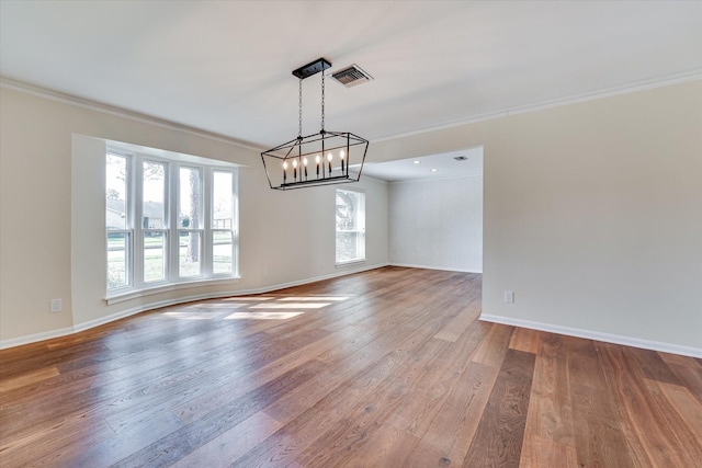 spare room with crown molding and hardwood / wood-style floors