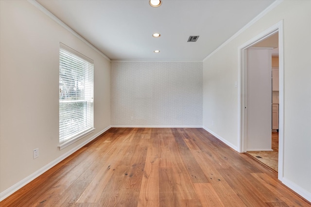 unfurnished room with ornamental molding and light hardwood / wood-style flooring