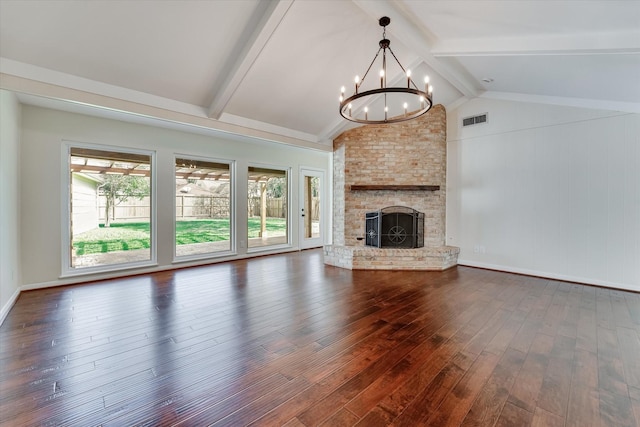 unfurnished living room with vaulted ceiling with beams, dark hardwood / wood-style floors, a large fireplace, and a chandelier