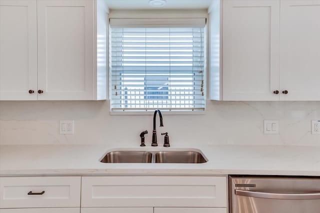 kitchen with white cabinetry, dishwasher, and sink