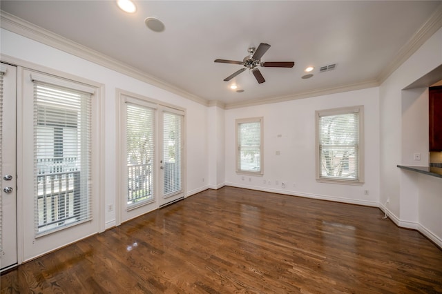 unfurnished living room with a ceiling fan, baseboards, visible vents, dark wood finished floors, and crown molding