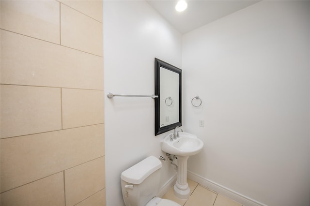 bathroom featuring baseboards, toilet, and tile patterned floors