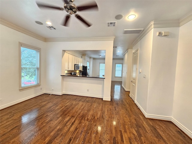 unfurnished living room with ornamental molding, dark wood-style flooring, and visible vents