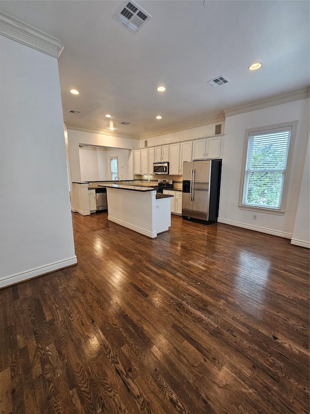 kitchen with dark countertops, white cabinetry, visible vents, and appliances with stainless steel finishes