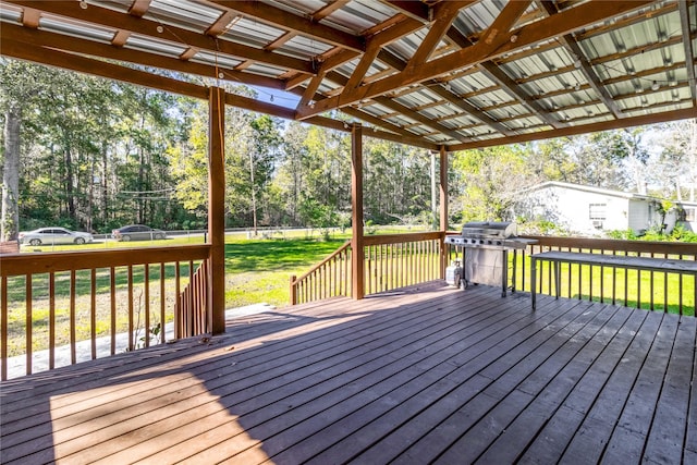 wooden terrace featuring area for grilling and a yard