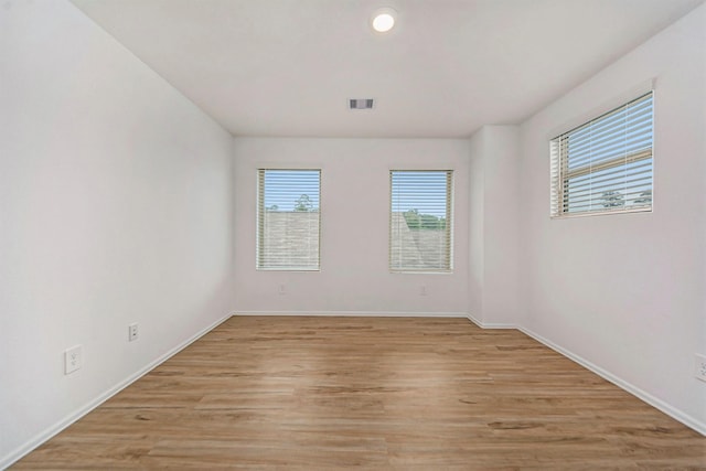 spare room featuring light hardwood / wood-style floors