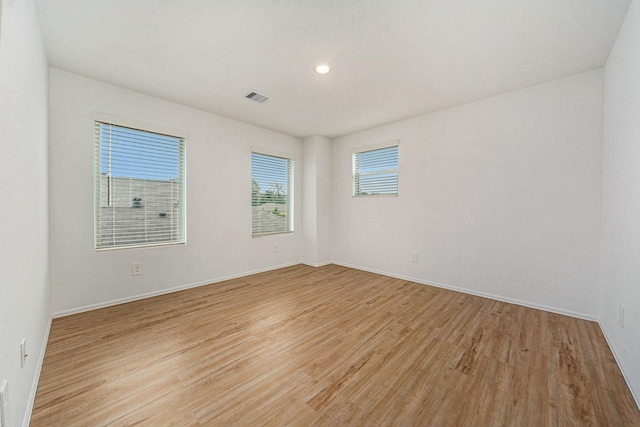 spare room featuring light hardwood / wood-style flooring