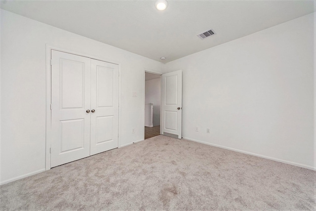 unfurnished bedroom with carpet floors and a closet