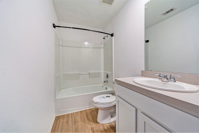 full bathroom featuring toilet, hardwood / wood-style floors, vanity, and  shower combination