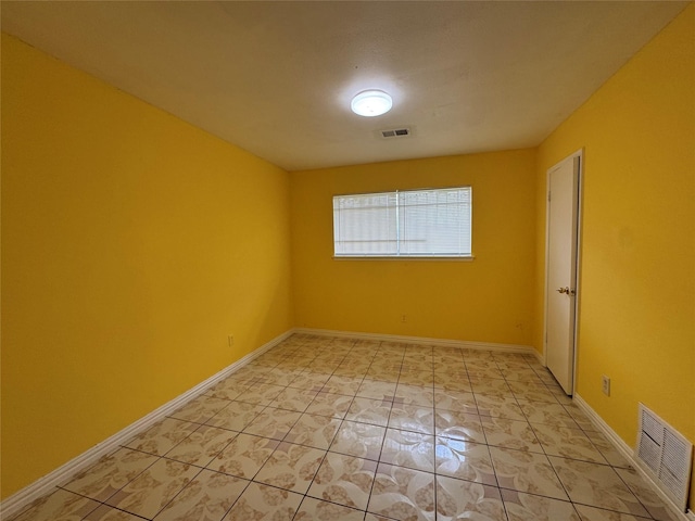 unfurnished room featuring light tile patterned flooring