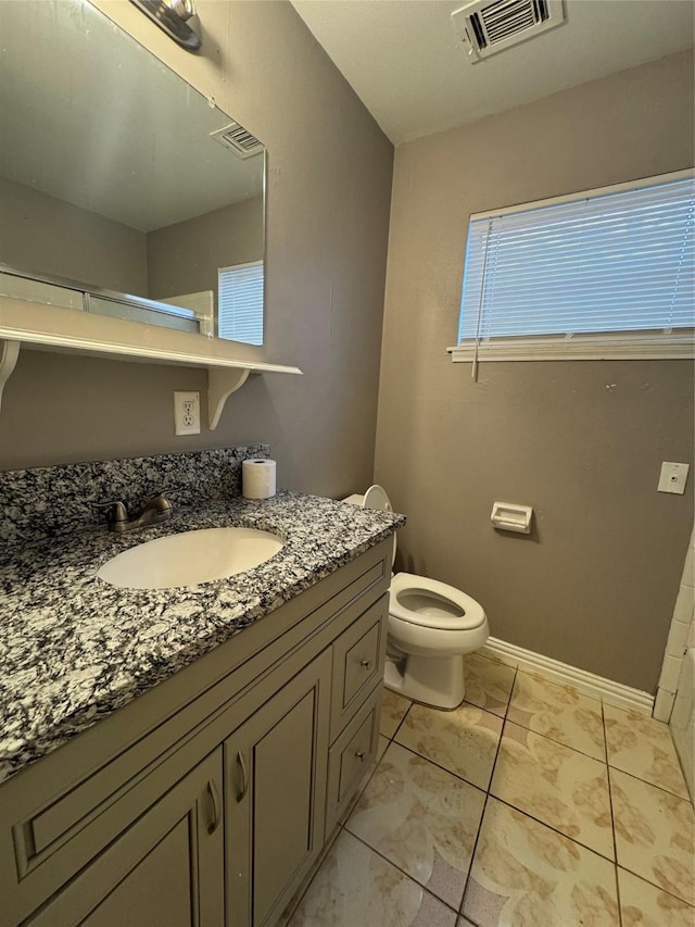 bathroom featuring vanity and toilet