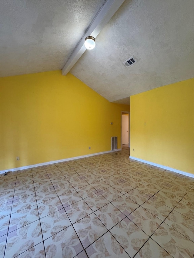 tiled empty room featuring a textured ceiling and vaulted ceiling with beams