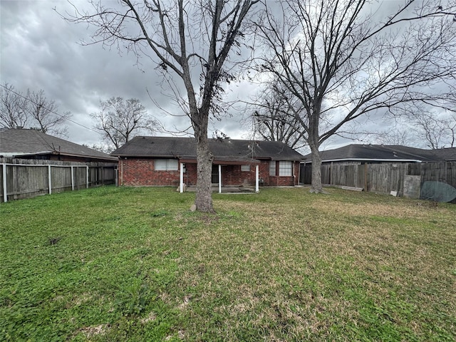 back of property featuring a yard