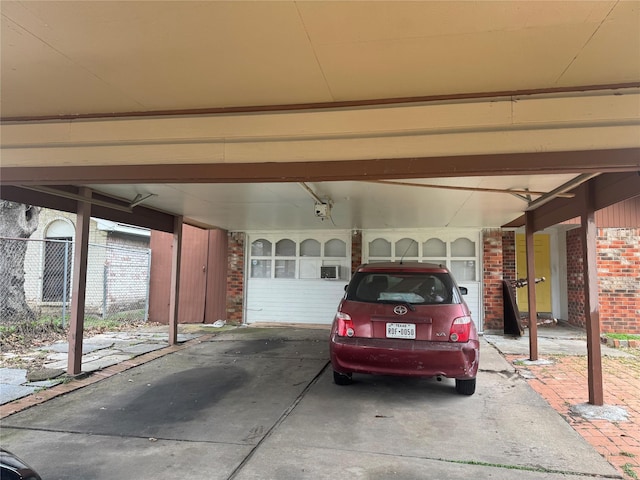 garage with a garage door opener and a carport