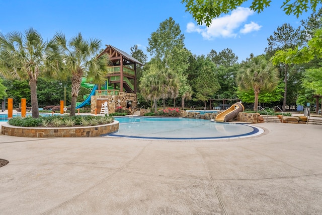 community pool with playground community and a water slide