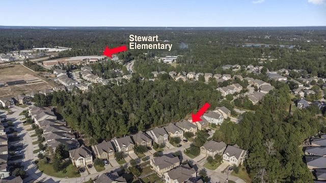 drone / aerial view with a residential view and a wooded view