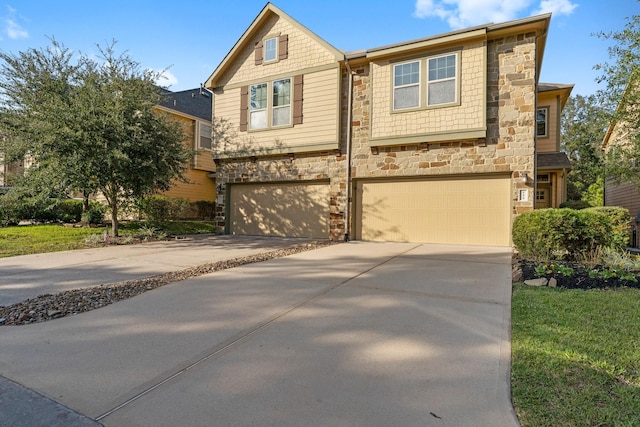 view of front of property featuring driveway, stone siding, and a garage