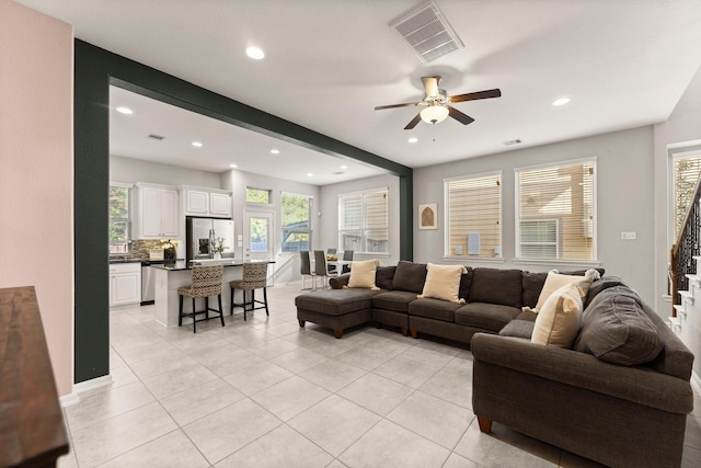 living room with light tile patterned floors, visible vents, and recessed lighting