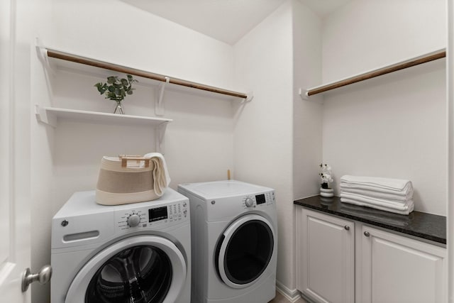 washroom with separate washer and dryer and cabinet space