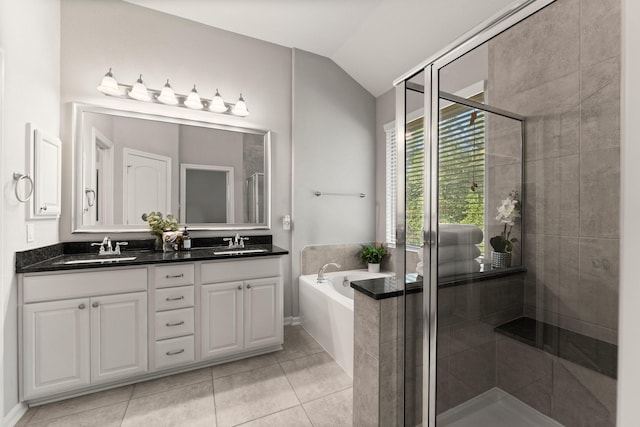 full bathroom featuring lofted ceiling, a stall shower, a sink, and a bath