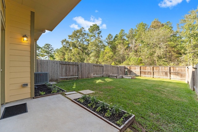 view of yard featuring central AC unit, a patio area, a fenced backyard, and a vegetable garden