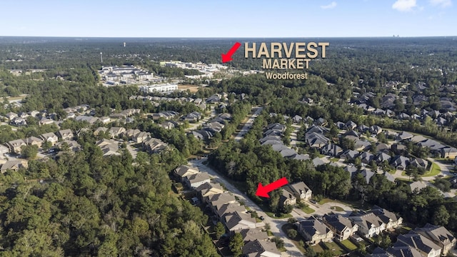 aerial view featuring a forest view and a residential view