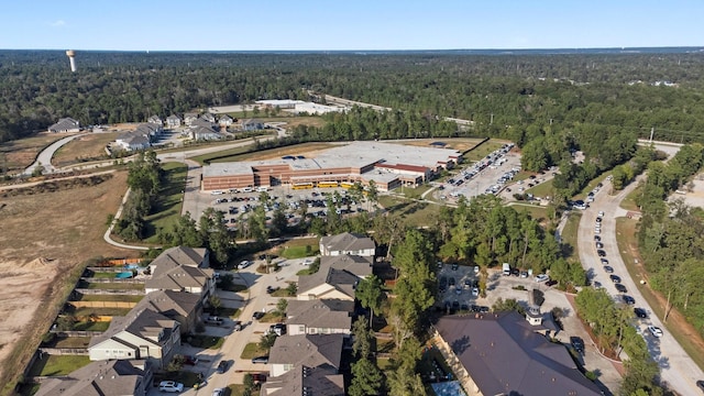 birds eye view of property featuring a view of trees