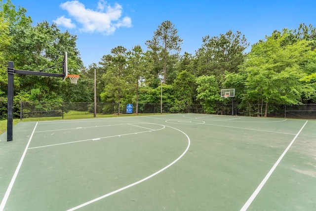 view of basketball court with community basketball court and fence