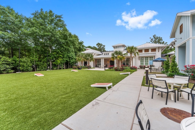 view of yard with outdoor dining space and a patio