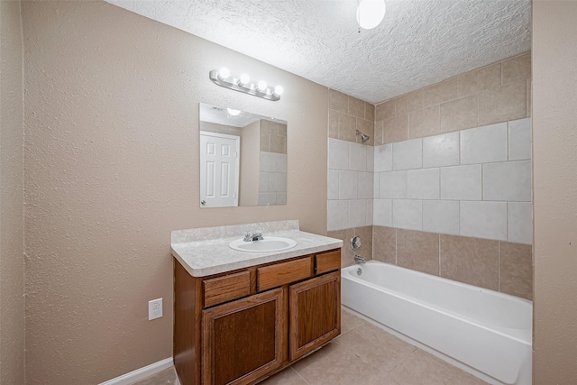 bathroom with vanity, a textured ceiling, tile patterned flooring, shower / bath combination, and a textured wall