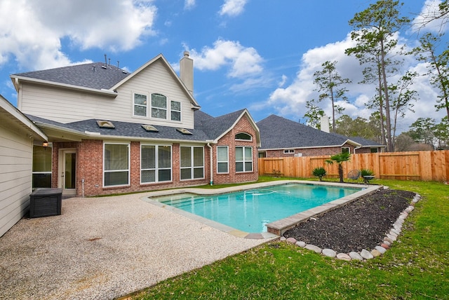 view of swimming pool featuring a yard and a patio area