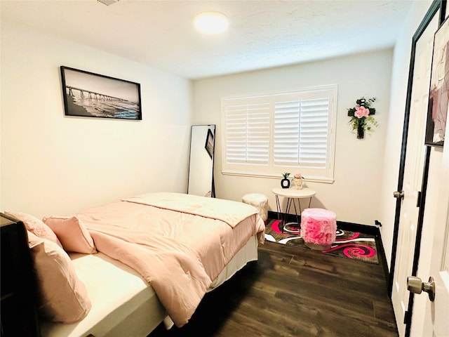 bedroom featuring dark wood-style floors