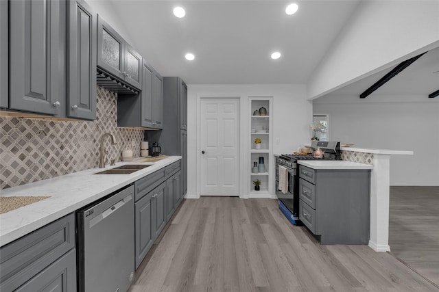 kitchen with light wood-type flooring, appliances with stainless steel finishes, sink, and gray cabinetry