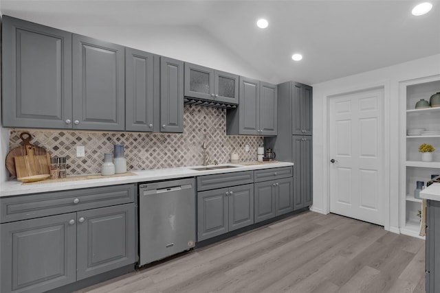 kitchen with stainless steel dishwasher, lofted ceiling, sink, and gray cabinetry