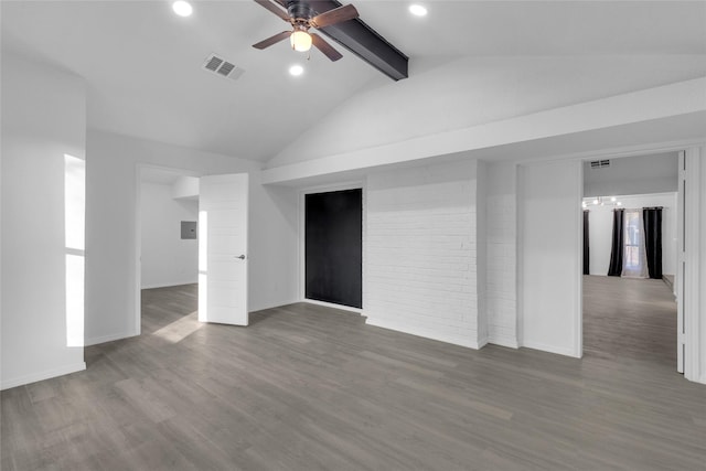 empty room featuring vaulted ceiling with beams, wood-type flooring, ceiling fan, and brick wall