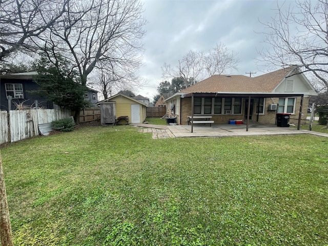 view of yard with a patio and a storage unit