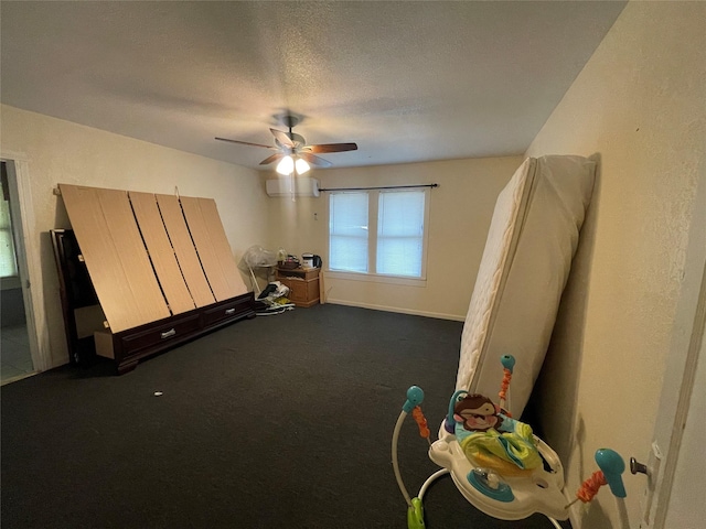 interior space featuring ceiling fan, a textured ceiling, and dark carpet