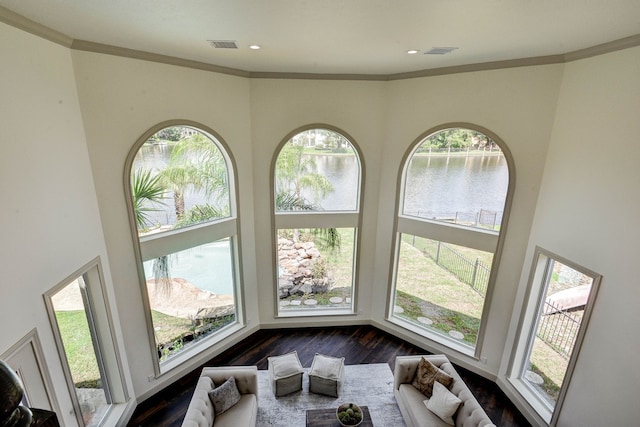 interior details featuring crown molding and a water view