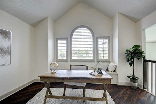 office area with dark hardwood / wood-style flooring, lofted ceiling, and a textured ceiling