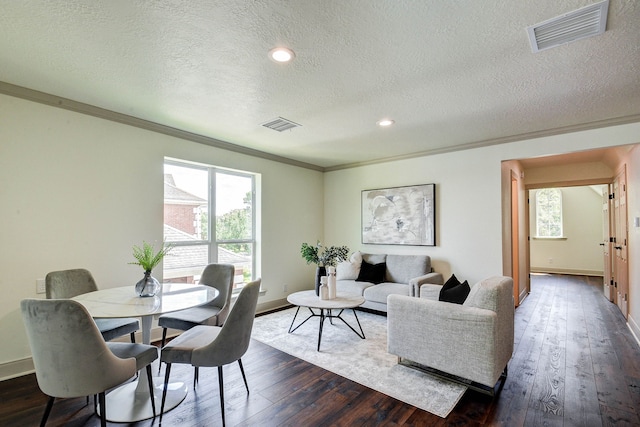 interior space featuring dark hardwood / wood-style flooring, plenty of natural light, ornamental molding, and a textured ceiling