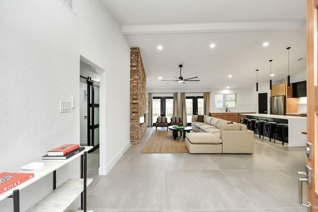 living room featuring vaulted ceiling with beams, sink, french doors, and ceiling fan