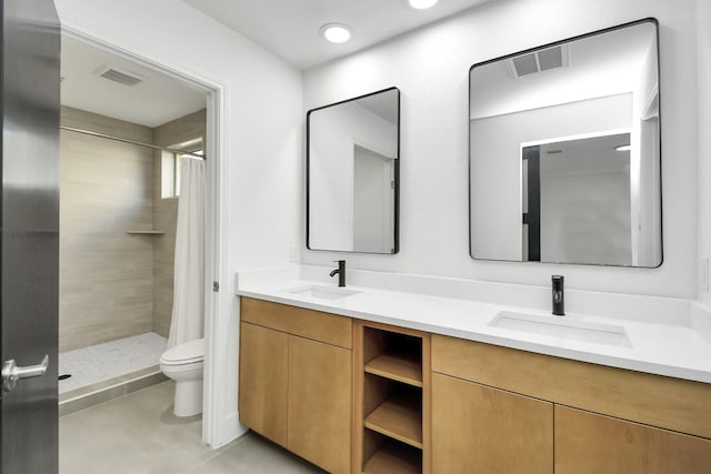 bathroom with tile patterned floors, vanity, toilet, and curtained shower